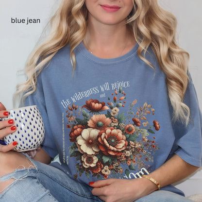 Christian t-shirt with boho design and Bible verse saying the wilderness will blossom in Comfort Colors blue jean color