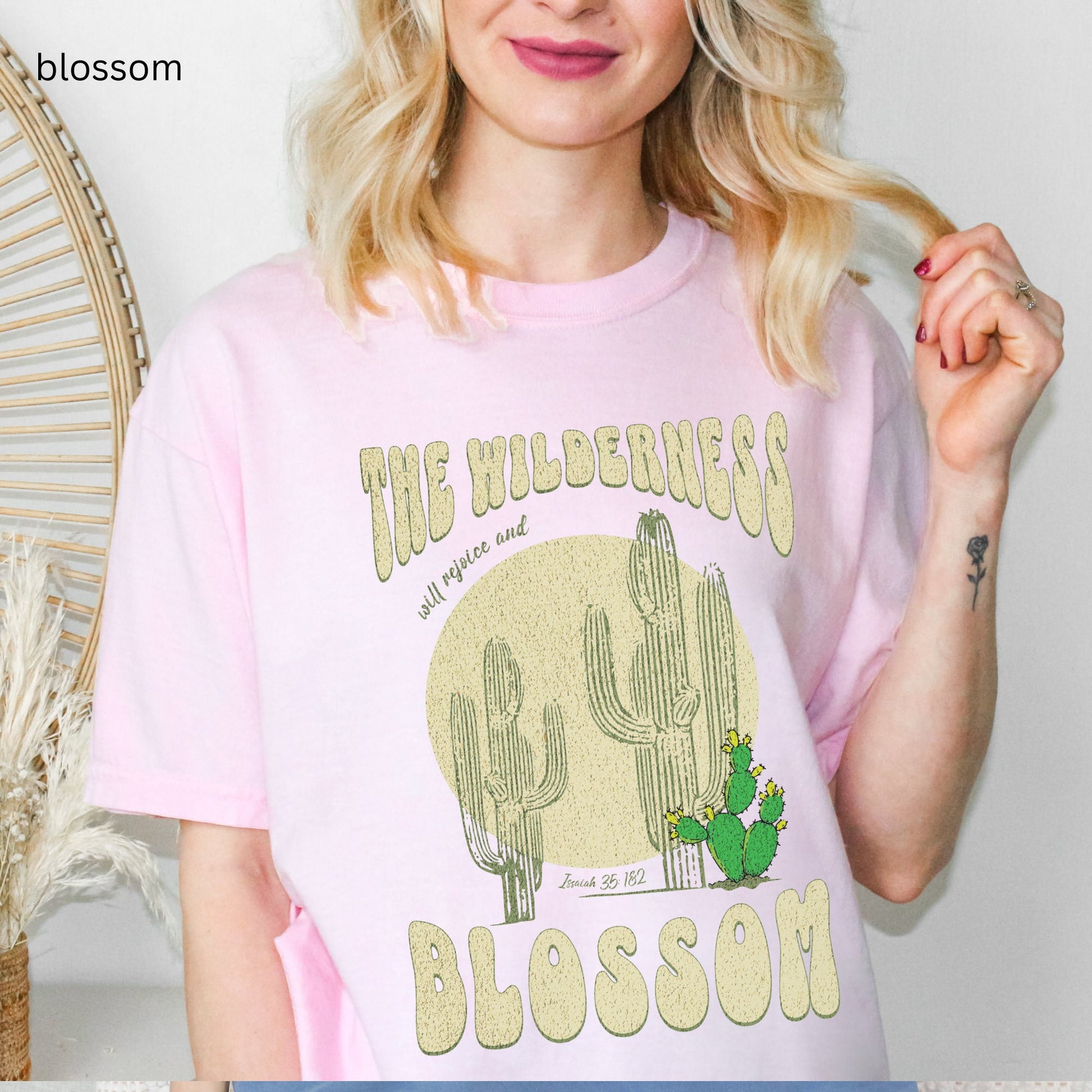 Christian t-shirt with boho design and Bible verse saying the wilderness will blossom in Comfort Colors blossom color