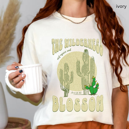 Christian t-shirt with boho design and Bible verse saying the wilderness will blossom in ivory color