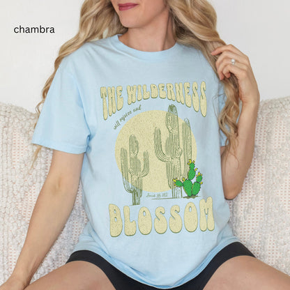 Christian t-shirt with boho design and Bible verse saying the wilderness will blossom in Comfort Colors chambray color