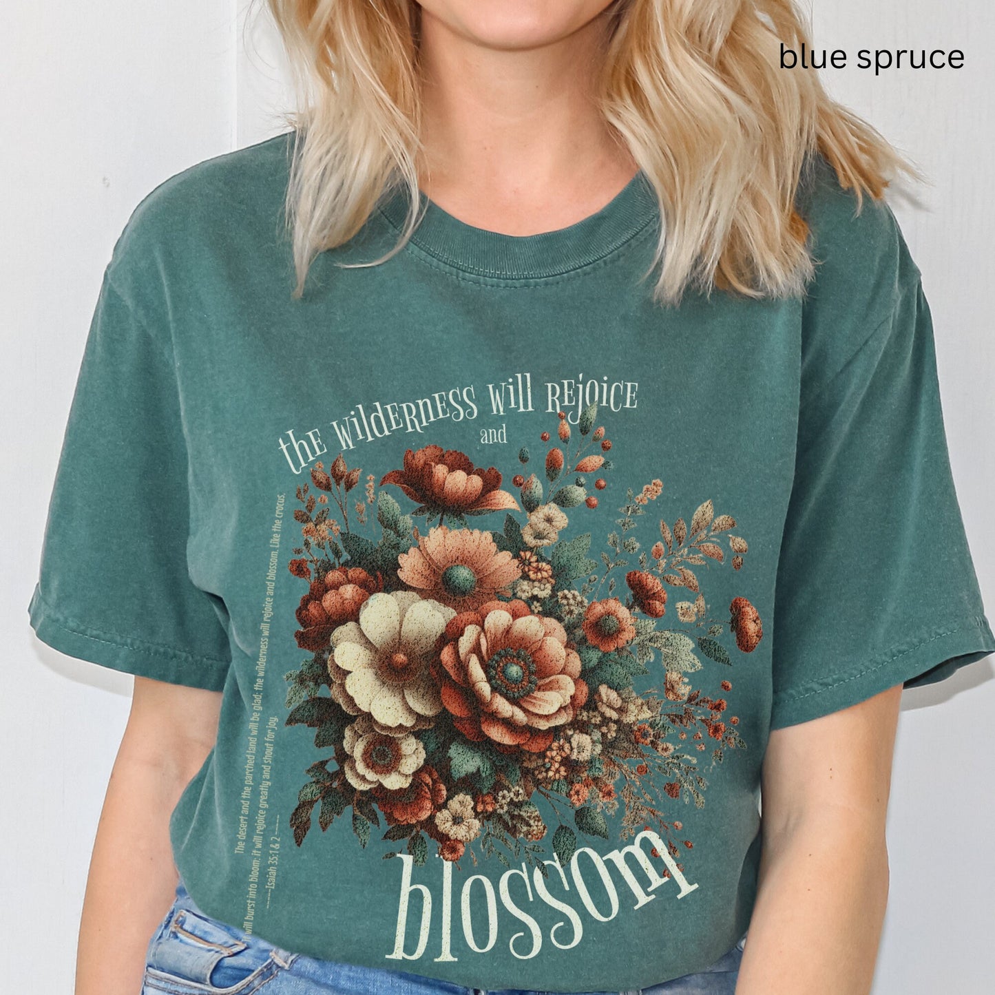 Christian t-shirt with boho design and Bible verse saying the wilderness will blossom in Comfort Colors blue spruce color