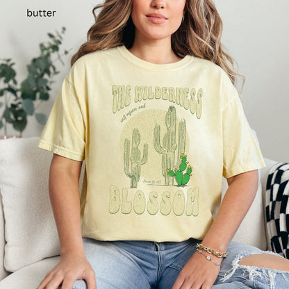 Christian t-shirt with boho design and Bible verse saying the wilderness will blossom in Comfort Colors butter color