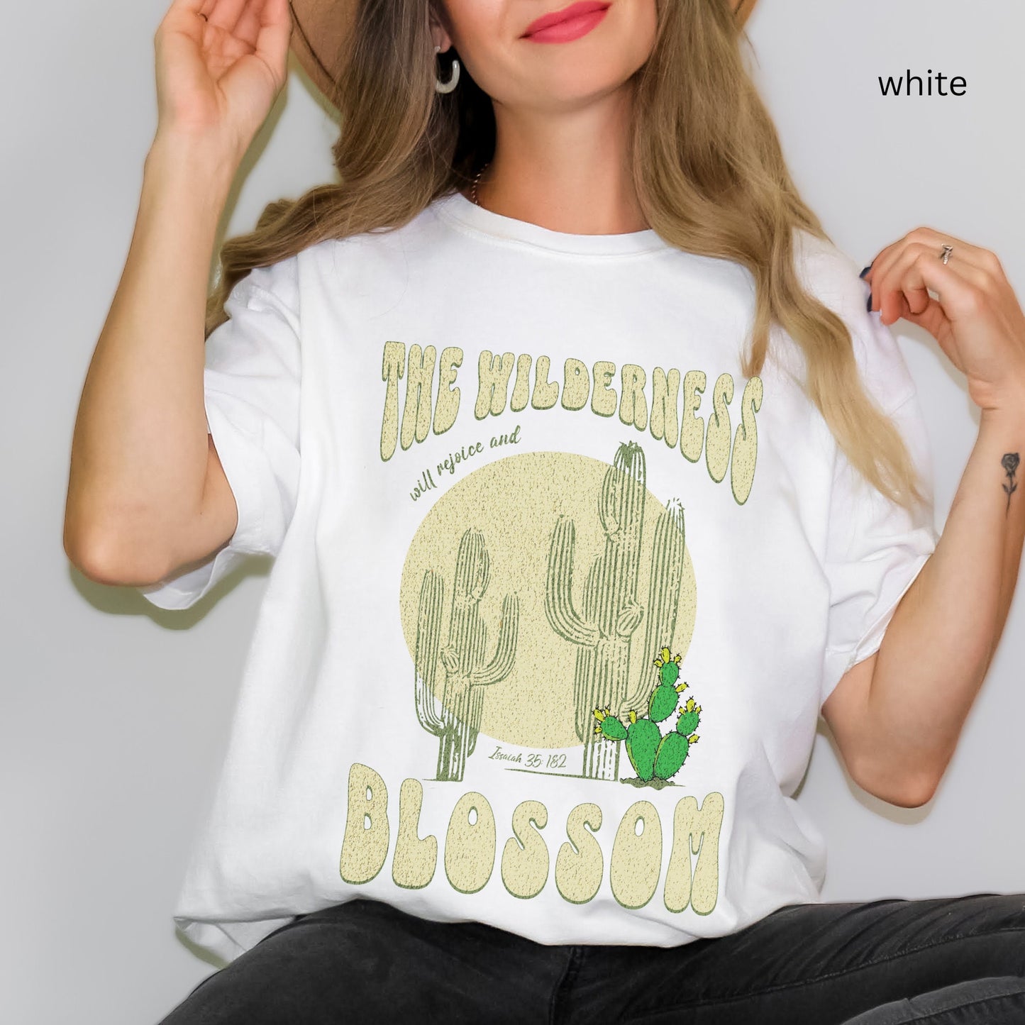 Christian t-shirt with boho design and Bible verse saying the wilderness will blossom in Comfort Colors white color